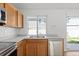 Updated kitchen area featuring stainless steel appliances, wood cabinets, and a window view at 19817 E 47Th Pl, Denver, CO 80249