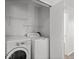 Functional laundry area with modern appliances, and storage shelves for convenience at 19817 E 47Th Pl, Denver, CO 80249