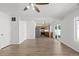 Open-concept living room and kitchen featuring hardwood floors and ample natural light at 19817 E 47Th Pl, Denver, CO 80249