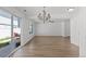 Open-concept living and dining area with hardwood floors and outdoor access to a patio at 19817 E 47Th Pl, Denver, CO 80249