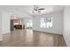 Spacious living room featuring hardwood floors, ceiling fan and an open-concept layout at 19817 E 47Th Pl, Denver, CO 80249