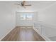 Well-lit loft area featuring wood-look flooring and a modern glass railing at 19817 E 47Th Pl, Denver, CO 80249