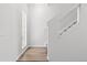 Bright stairway with modern design, hardwood floors, and white walls and trim at 19817 E 47Th Pl, Denver, CO 80249