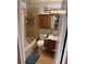 Compact bathroom featuring tiled shower, vanity, and wood-look flooring at 596 Trumbull Ln, Monument, CO 80132