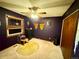 Cozy bedroom with dark walls, ceiling fan, and decorative butterfly at 596 Trumbull Ln, Monument, CO 80132