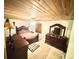Charming bedroom with wood-paneled ceiling, dresser, and plush bed at 596 Trumbull Ln, Monument, CO 80132