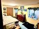 Cozy bedroom with a vintage desk, comfortable bed, and bright natural light from the large window at 596 Trumbull Ln, Monument, CO 80132
