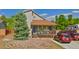 Charming home with a welcoming front porch, well-manicured lawn and a rock garden in the front yard at 596 Trumbull Ln, Monument, CO 80132