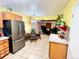 Bright, open kitchen showcasing stainless appliances, tile floors, and adjacent dining area at 596 Trumbull Ln, Monument, CO 80132