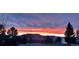 Scenic view of a vibrant sunset over the mountains and neighborhood at 596 Trumbull Ln, Monument, CO 80132