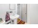Bathroom with a pedestal sink, wood floors, and a towel rack, offering a clean, classic design at 5567 E Asbury Ave, Denver, CO 80222