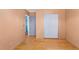 Bedroom featuring wood floors, light peach walls, and a closet with sliding doors at 5567 E Asbury Ave, Denver, CO 80222