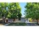 Charming single-story home with a well-maintained lawn and mature trees providing ample shade at 5567 E Asbury Ave, Denver, CO 80222