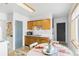 Compact eat-in kitchen featuring ample storage and a view to the dining room at 5567 E Asbury Ave, Denver, CO 80222