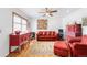 Cozy living room featuring hardwood floors, a ceiling fan, and ample natural light at 5567 E Asbury Ave, Denver, CO 80222