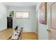 A cozy office space featuring wood floors, a window with blinds, and light blue walls at 5567 E Asbury Ave, Denver, CO 80222
