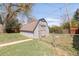 Backyard shed featuring a shingled roof, chain-link fence, and grass area at 5567 E Asbury Ave, Denver, CO 80222