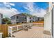 A wooden deck with furniture and a white railing offers a cozy outdoor space with a wood fence for privacy at 8065 Clay St, Westminster, CO 80031