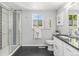 Bathroom featuring a tiled shower with glass door and a vanity with a dark countertop at 8065 Clay St, Westminster, CO 80031