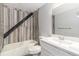 Bathroom with neutral-toned shower surround, white vanity, and modern fixtures at 8065 Clay St, Westminster, CO 80031