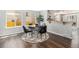 Bright dining space with hardwood floors, modern table, and seamless flow to adjacent kitchen area at 8065 Clay St, Westminster, CO 80031