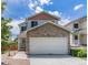Charming two-story home with a stone-accented garage and well-maintained lawn under a cloudy sky at 8065 Clay St, Westminster, CO 80031