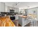 Modern kitchen featuring gray cabinetry, wood countertops, black backsplash and stainless steel appliances at 8065 Clay St, Westminster, CO 80031