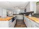 Renovated kitchen with butcher block counters, stainless steel sink, and stylish gray cabinetry at 8065 Clay St, Westminster, CO 80031