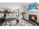 Open concept living space with stylish kitchen, fireplace, and comfortable seating arrangement at 8065 Clay St, Westminster, CO 80031