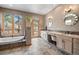 Serene bathroom with a soaking tub, dual vanities, and natural light creates a spa-like experience at 394 S Ponderosa Way, Evergreen, CO 80439