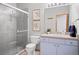 Clean bathroom features glass shower, a toilet, and a light blue vanity at 394 S Ponderosa Way, Evergreen, CO 80439
