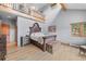 Cozy bedroom with vaulted ceilings, a decorative headboard, natural light, and ample space provides comfort and style at 394 S Ponderosa Way, Evergreen, CO 80439