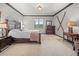 Comfortable bedroom features a bed, nice furnishings, and a view to the exterior at 394 S Ponderosa Way, Evergreen, CO 80439