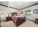 Inviting bedroom with a sleigh bed, bedside tables, and a window with a view at 394 S Ponderosa Way, Evergreen, CO 80439