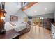 Bright bedroom featuring vaulted ceilings, a balcony, hardwood floors, and large windows offering beautiful natural light at 394 S Ponderosa Way, Evergreen, CO 80439