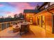 Spacious deck featuring outdoor seating, a fire pit, and scenic views, perfect for relaxing and entertaining guests at 394 S Ponderosa Way, Evergreen, CO 80439