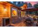 Outdoor dining area with patio furniture, wood deck, and views of the backyard at 394 S Ponderosa Way, Evergreen, CO 80439