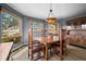 Elegant dining room with hardwood floors, custom windows, and views of the wooded landscape, perfect for formal dining at 394 S Ponderosa Way, Evergreen, CO 80439