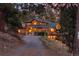 Inviting exterior view of a wood-clad home with a charming front porch and beautiful stonework at 394 S Ponderosa Way, Evergreen, CO 80439