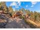 Exterior showcasing beautiful wood siding and well-manicured landscaping at 394 S Ponderosa Way, Evergreen, CO 80439