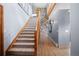 Grand foyer showcases a staircase and a stone accent wall with wooden beams, creating a welcoming entrance at 394 S Ponderosa Way, Evergreen, CO 80439