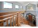 Bright foyer featuring large windows with scenic views, a wooden banister, and a staircase leading to the main level at 394 S Ponderosa Way, Evergreen, CO 80439