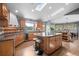 Well-lit kitchen with a large island, granite counters, modern appliances, and a breakfast bar for casual dining at 394 S Ponderosa Way, Evergreen, CO 80439