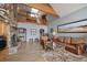 Inviting living room with stone fireplace, wood beams, loft and cozy seating area, perfect for gathering and relaxation at 394 S Ponderosa Way, Evergreen, CO 80439