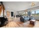 Expansive living room features hardwood floors, large windows, and open layout at 394 S Ponderosa Way, Evergreen, CO 80439