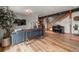 Open-concept living room featuring wood floors, a staircase, and a comfortable seating area at 394 S Ponderosa Way, Evergreen, CO 80439