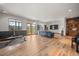 Spacious living room with hardwood floors, a view to the exterior, and access to a patio at 394 S Ponderosa Way, Evergreen, CO 80439