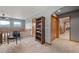 Open loft area with a bookshelf, ceiling fan, and natural light, perfect for a reading nook or study area at 394 S Ponderosa Way, Evergreen, CO 80439