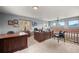 Spacious home office with multiple desks and large windows offering scenic views, ideal for a productive workspace at 394 S Ponderosa Way, Evergreen, CO 80439