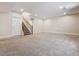 Spacious finished basement with carpet flooring and staircase at 13986 Lexington Dr, Parker, CO 80134